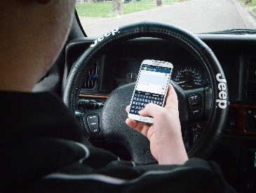Person texting whilst driving.